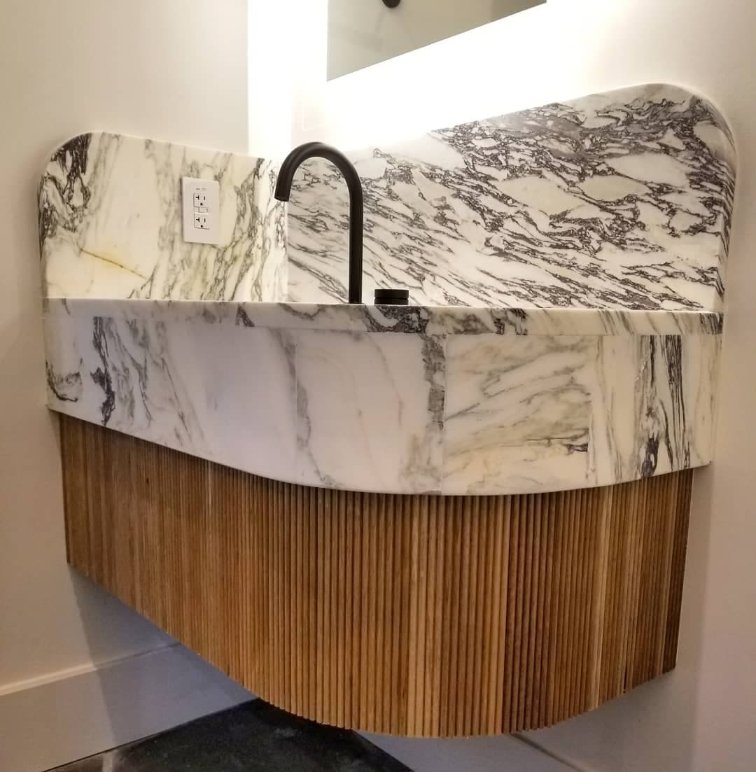 Luxury Marble Vanity with Wood Slat Accent - European frameless cabinets in Austin, TX